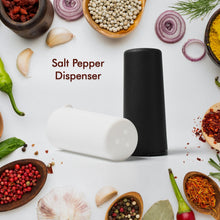 Salt and pepper dispensers on table