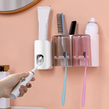 Multi-functional toothbrush holder with automatic toothpaste dispenser.