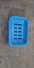 Covered plastic soap holder, helps in maintaining soap longevity.